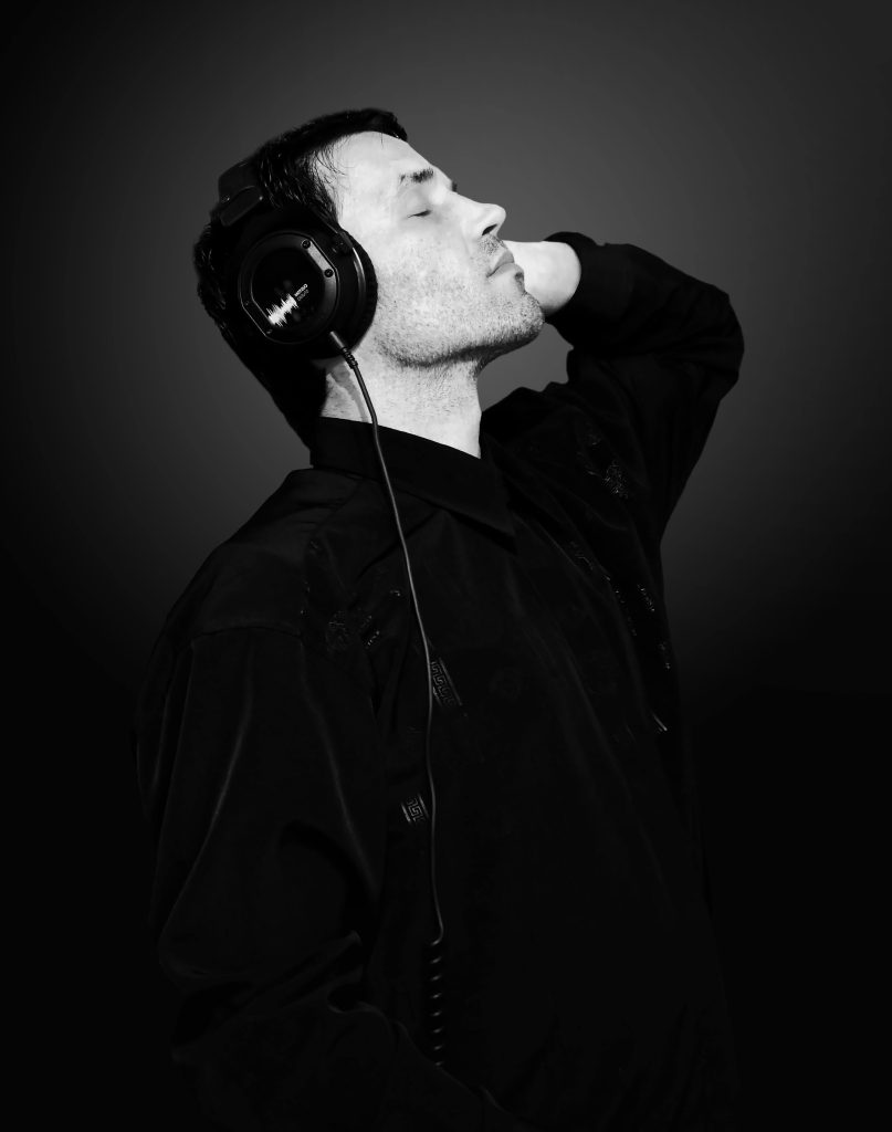 “A chill dude with headphones on, looking like he’s either brainstorming his next big innovation idea or just vibing to his playlist while pretending to work — classic KVKS student energy at its finest.”