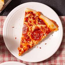 A lone slice of pizza sitting proudly — the true fuel behind every student innovation project ever. Forget caffeine, this is what powers genius.”